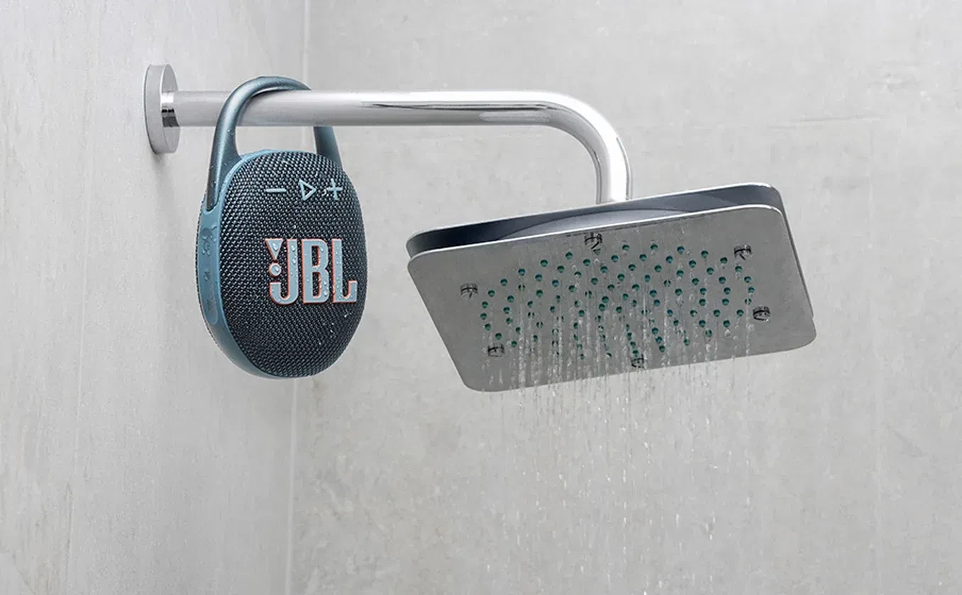 JBL Clip 5 integrated carabiner with wide opening clipped to shower pipe demonstrating versatile portability